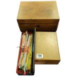 A small oak box containing sewing accessories and