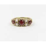 A 9ct gold garnet and split pearl ring, in the Vic