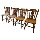 A set of four modern pine dining chairs