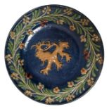 A late 19th century glazed pottery wall plate cent