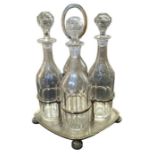 Four Edwardian faceted glass decanters contained i