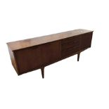 A mid century teak sideboard with three short draw