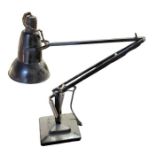 An angle poise lamp, black painted, with square we