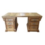A 20th century pine twin pedestal desk, with six s
