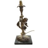 A decorative gilt metal table lamp cast as a putto