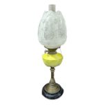 A Victorian oil lamp having moulded yellow glazed
