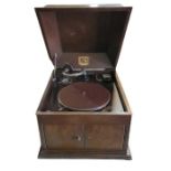 A HMV table top wind up gramophone in oak case wit