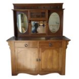 An oak Arts and Crafts style sideboard the mirrore