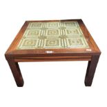 A mid century rosewood coffee table with green gla