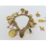 A 9ct gold double link charm bracelet with various