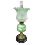 A Victorian oil lamp having green and cream glazed