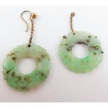 A pair of jade earrings, the round stones with car