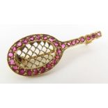 A 9ct gold ruby set brooch in the form of a tennis