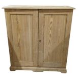 A late 19th century stripped pine cupboard, the pa