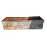 A galvanised drinking trough 155cm x 48cm wide