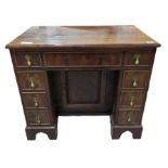 A mahogany 18th century style kneehole desk with c