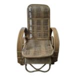 A woven cane lounger with adjustable back and pull