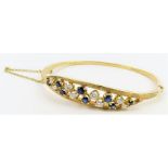 An 18ct gold sapphire and diamond hinged bangle, t