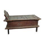 An Asian hardwood day bed having shaped raised end