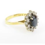 An 18ct gold sapphire and diamond cluster ring, fi