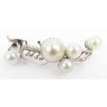 A cultured pearl brooch, the vari-sized pearls set