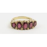 A 9ct gold garnet five stone ring, finger size N,