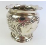 A 20th century silver embossed pot, with a crimped