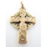 A Celtic cross with engraved decoration, 3cm long