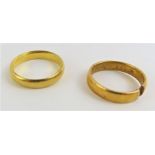 A 22ct gold wedding band, finger size P; together