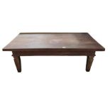 A low rectangular hardwood table on square taperin