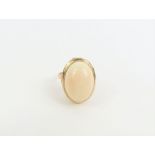 A single stone shell dress ring, the light cabocho