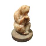 A carved marble figure of a seated bear drinking f