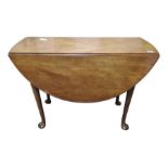 A George III oval mahogany drop flap table on tape