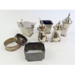 A sterling silver Art Deco three piece cruet set,