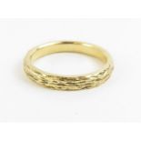 A 9ct gold wedding band, with bark effect decorati