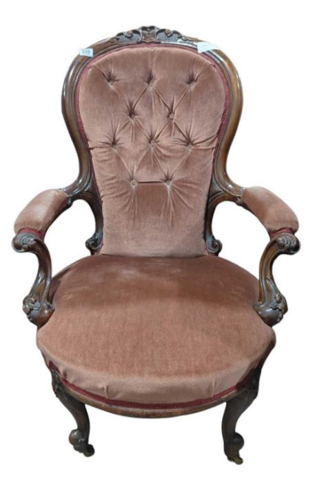 A Victorian button back and upholstered open arm c
