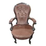 A Victorian button back and upholstered open arm c