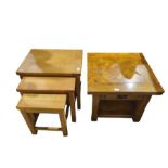 A nest of three oak tables together with a low cen