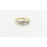 An 18ct gold three stone diamond ring, the stones