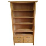 A modern light oak open fronted bookcase with four