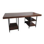 A large hardwood desk on black painted metal suppo