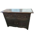 A dark oak sideboard fitted with drawers and cupbo