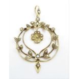 An Edwardian seed pearl pendant, of round wreath t