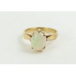 A white opal single stone ring in a six claw setti