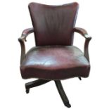An Edwardian red leather office swivel chair on ca