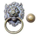 A cast brass lions head door knocker with loose rin