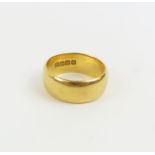 A wide 22ct gold wedding band, finger size K 1/2 c