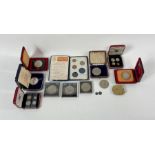 A collection of coins to include two cased sets of