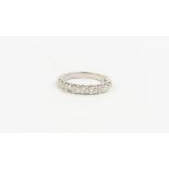 A platinum diamond eight stone half eternity ring,