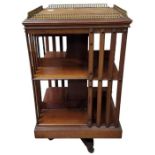 A Victorian walnut revolving bookcase having brass